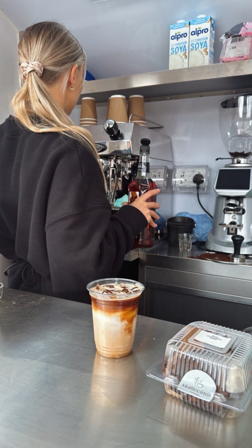 Molly making an iced mocha with a food box on the counter