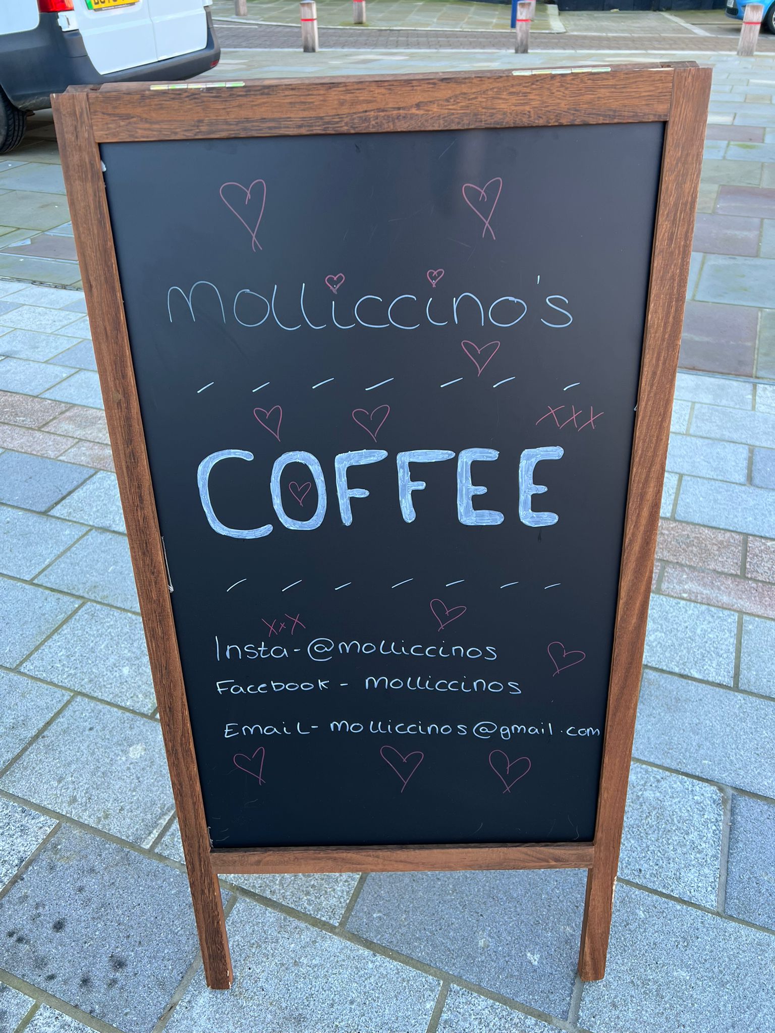 Molliccino's Coffee chalkboard A-board sign showing Instagram, Facebook and email