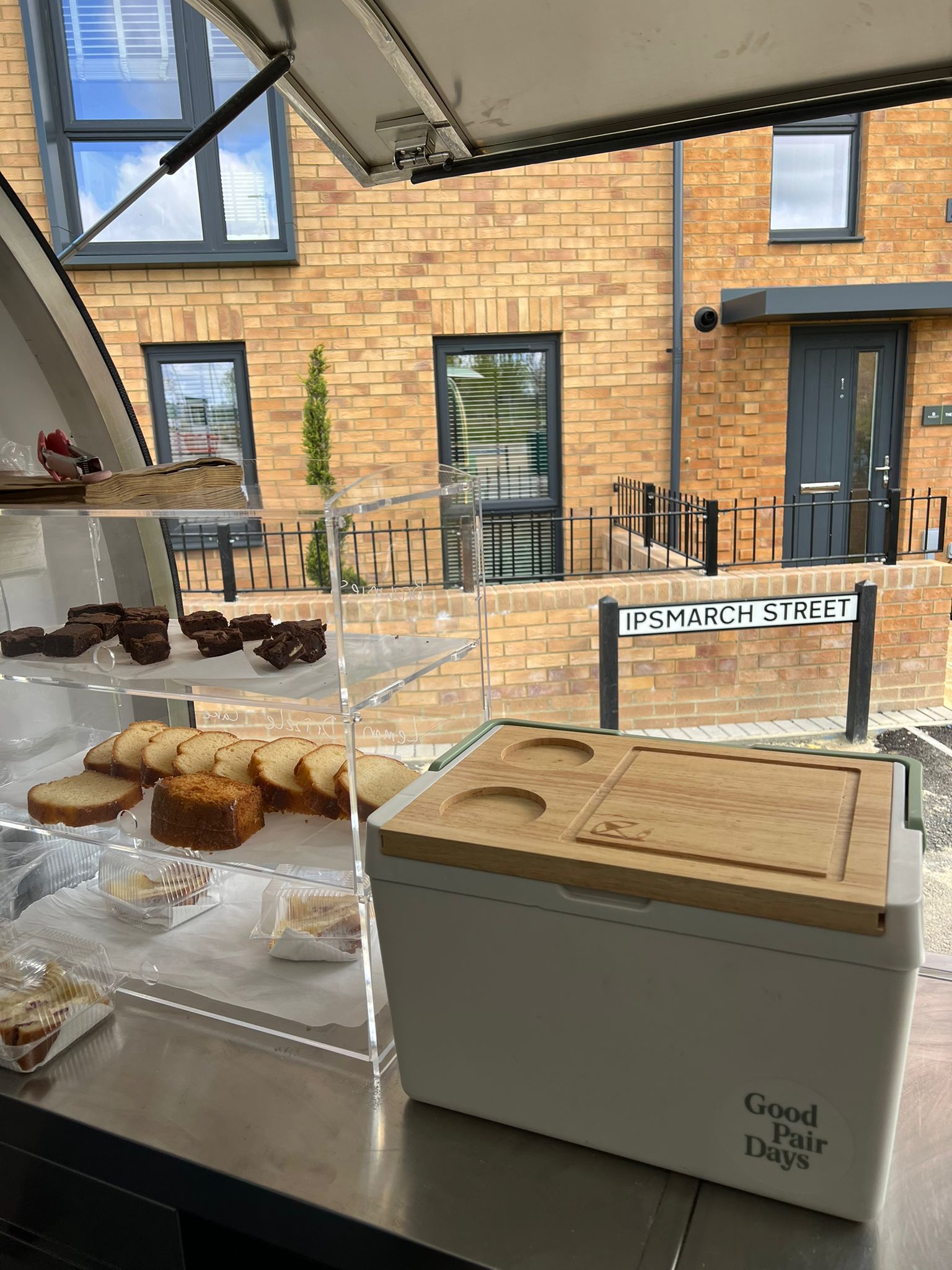 Food display cabinet showing brownies, traybakes and slices at an event